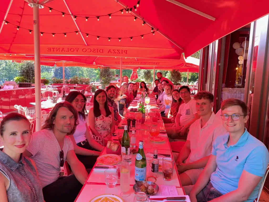 A large group of people dining at a long table.