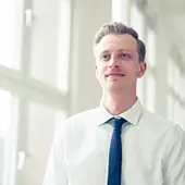 Professional man in white shirt and blue tie smiling