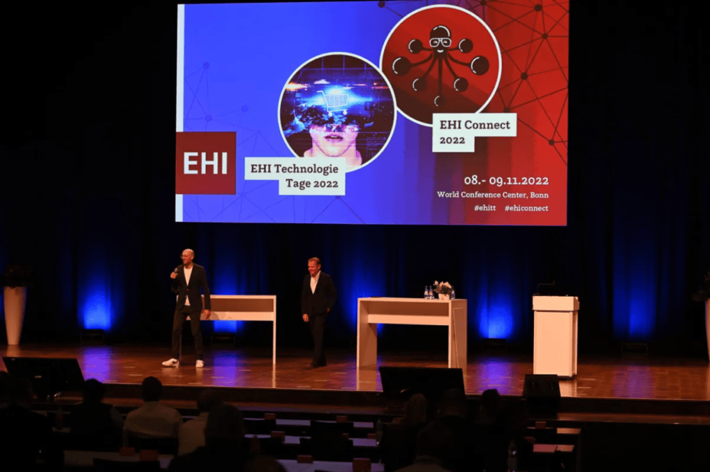 Two speakers on stage at EHI Connect 2022 conference.
