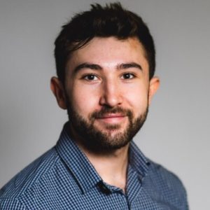 Portrait of a man with a beard and checkered shirt.