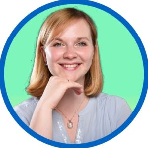Smiling woman with strawberry blonde hair in a circular frame.