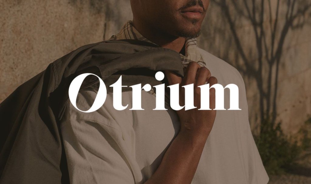 Man in white shirt with 'Otrium' brand name overlay.