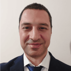 A man in a suit and tie smiling.