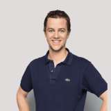 Smiling man wearing a navy blue polo shirt