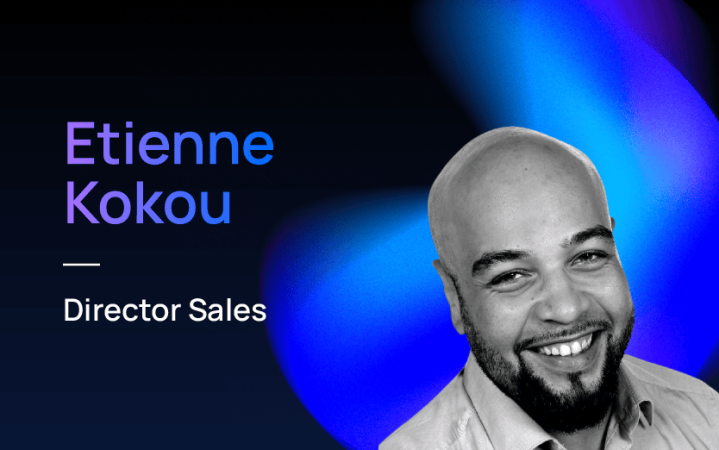 Etienne Kokou, Director Sales, smiling with a blue background.